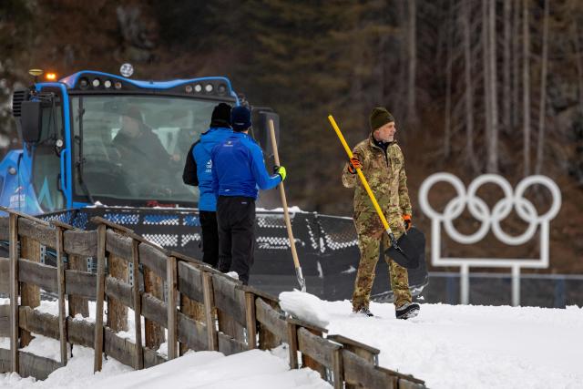 Staff members work on the snow prepping at the Biathlon venue in Antholz, northern Italy prior to the Milano Cortina 2026 Olympic Games, on January 23, 2026. (Photo by Odd ANDERSEN / AFP)