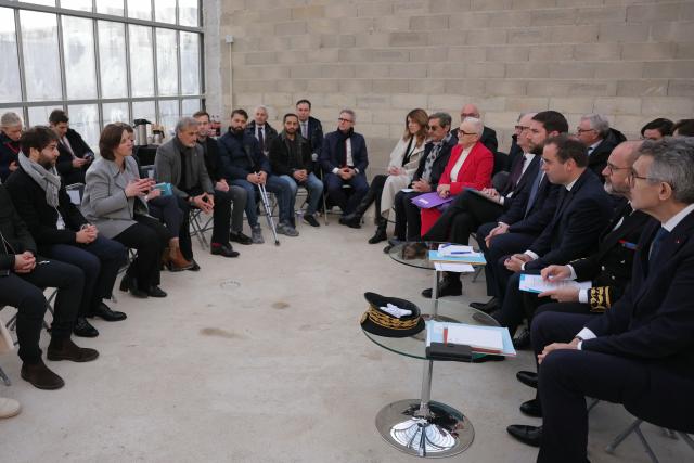 France's Prime Minister Sebastien Lecornu (3rd R) meets with officials and project stakeholders of a housing project during a visit dedicated to housing in Rosny-sous-Bois, in the suburb of Paris on January 23, 2026. (Photo by Thomas SAMSON / AFP)