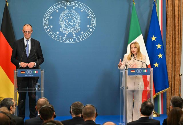 Italy's Prime Minister Giorgia Meloni and Germany's Chancellor Friedrich Merz address a press conference after attending an Intergovernmental summit between Italy and Germany, at Villa Doria Pamphilj in Rome on January 23, 2026. (Photo by Andreas SOLARO / AFP)