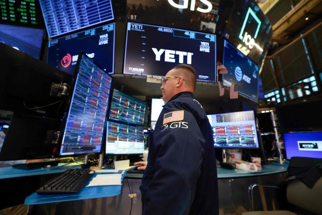 A trader works on the floor of the New York Stock Exchange (NYSE) at the opening bell in New York on January 23, 2026. Stocks were subdued and precious metals hit fresh highs Friday after a turbulent week that saw US President Donald Trump back down from threats to seize Greenland and to issue tariffs against European allies. (Photo by TIMOTHY A. CLARY / AFP)