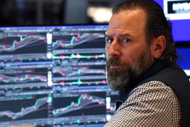 A trader works on the floor of the New York Stock Exchange (NYSE) at the opening bell in New York on January 23, 2026. Stocks were subdued and precious metals hit fresh highs Friday after a turbulent week that saw US President Donald Trump back down from threats to seize Greenland and to issue tariffs against European allies. (Photo by TIMOTHY A. CLARY / AFP)