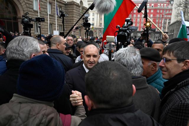 Outgoing Bulgaria's President Rumen Radev (C) meets with supporters as he leaves the Bulgarian Presidency parade entrance after attending the handover ceremony with the new president and current Vice President, in Sofia on January 23, 2026. Radev announced his resignation on January 19, 2026, ahead of snap elections expected in spring, deepening political turmoil in the EU and NATO member. (Photo by Nikolay DOYCHINOV / AFP)