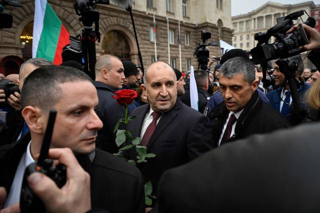 Outgoing Bulgaria's President Rumen Radev (C) meets with supporters as he leaves the Bulgarian Presidency parade entrance after attending the handover ceremony with the new president and current Vice President, in Sofia on January 23, 2026. Radev announced his resignation on January 19, 2026, ahead of snap elections expected in spring, deepening political turmoil in the EU and NATO member. (Photo by Nikolay DOYCHINOV / AFP)