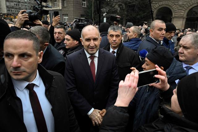 Outgoing Bulgaria's President Rumen Radev (C) meets with supporters as he leaves the Bulgarian Presidency parade entrance after attending the handover ceremony with the new president and current Vice President, in Sofia on January 23, 2026. Radev announced his resignation on January 19, 2026, ahead of snap elections expected in spring, deepening political turmoil in the EU and NATO member. (Photo by Nikolay DOYCHINOV / AFP)