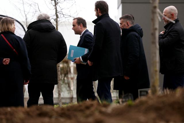 France's Prime Minister Sebastien Lecornu (C-L) visits a housing project in Rosny-sous-Bois, in the suburb of Paris on January 23, 2026. (Photo by Thomas SAMSON / AFP)