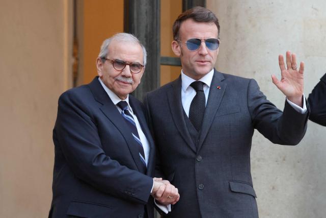 France's President Emmanuel Macron (R) wearing sunglasses shakes hands with Lebanon's Prime Minister Nawaf Salam prior to their meeting at the Elysee presidential palace in Paris, on January 23, 2026. (Photo by Ludovic MARIN / AFP)