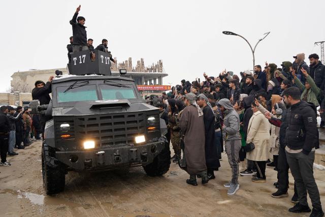 Members of Kurdish-led Syrian Democratic Forces (SDF) arrive at the Kurdish-held city of Ain al-Arab, also known as Kobane on January 23, 2026, after they withdrew from the Al-Aqtan prison in the Raqa province of Syria. Europeans were among 150 senior Islamic State group detainees transferred this week by the US military from Kurdish custody in Syria to Iraq, whose premier urged EU countries to repatriate their nationals. They were among an estimated 7,000 jihadists due to be moved across the border to Iraq as the Kurdish-led force that has held them for years relinquishes swathes of territory to the advancing Syrian army. (Photo by AFP)