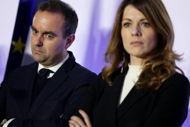 France's Prime Minister Sebastien Lecornu (L) and France's Government Spokesperson Maud Bregeon listen to the speech of France's Housing Minister during a visit to a housing project in Rosny-sous-Bois, in the suburb of Paris on January 23, 2026. (Photo by Thomas SAMSON / AFP)