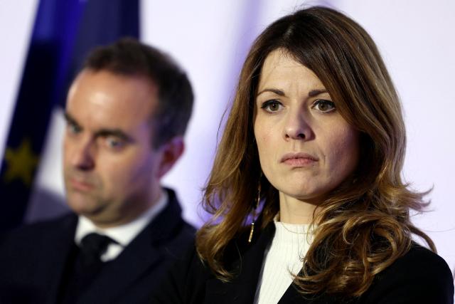 France's Prime Minister Sebastien Lecornu (L) and France's Government Spokesperson Maud Bregeon listen to the speech of France's Housing Minister during a visit to a housing project in Rosny-sous-Bois, in the suburb of Paris on January 23, 2026. (Photo by Thomas SAMSON / AFP)