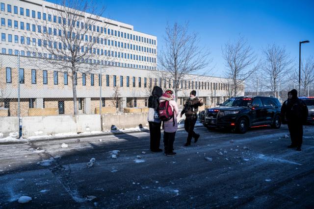 Officers of the Hennepin County Sheriffs Office approach an activist after some protesters attempted to block the street in front of the Bishop Henry Whipple Federal Building during the "ICE out of Minnesota: Day of Truth and Freedom" protest in Minneapolis, Minnesota on January 23, 2026. The Pentagon has ordered 1,500 US soldiers to prepare for a possible deployment to a state roiled by unrest over an immigration crackdown, US media reported on January 18. The reported preparations come days after President Donald Trump threatened to invoke the Insurrection Act, which enables use of the military to suppress "armed rebellion" or "domestic violence" -- although a day later he said there was no immediate need for it. (Photo by ROBERTO SCHMIDT / AFP)