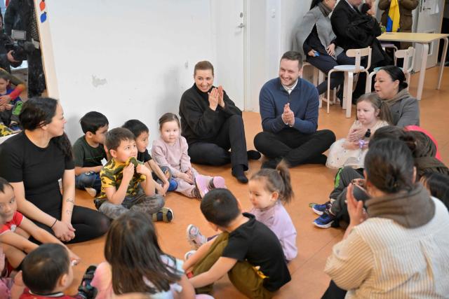 Denmark's Prime Minister Mette Frederiksen and Greenland's Prime Minister Jens-Frederik Nielsen visit a kindergarten in Nuuk, Greenland, on January 23, 2026. Frederiksen held talks with her Greenlandic counterpart after a turbulent week that saw US President Donald Trump back down from his threats to seize the Arctic island and agree to talks. Frederiksen travelled to the Greenland capital Nuuk from Brussels, where she held talks earlier with NATO Secretary General Mark Rutte, who reached a purported deal with Trump on Greenland at the World Economic Forum in Davos. (Photo by Oscar Scott Carl / Ritzau Scanpix / AFP) / Denmark OUT