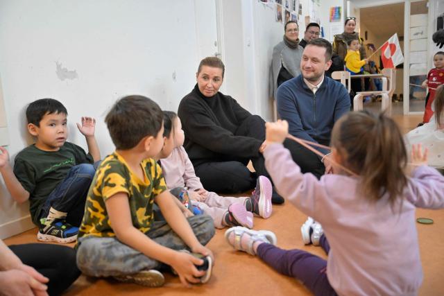 Denmark's Prime Minister Mette Frederiksen and Greenland's Prime Minister Jens-Frederik Nielsen visit a kindergarten in Nuuk, Greenland, on January 23, 2026. Frederiksen held talks with her Greenlandic counterpart after a turbulent week that saw US President Donald Trump back down from his threats to seize the Arctic island and agree to talks. Frederiksen travelled to the Greenland capital Nuuk from Brussels, where she held talks earlier with NATO Secretary General Mark Rutte, who reached a purported deal with Trump on Greenland at the World Economic Forum in Davos. (Photo by Oscar Scott Carl / Ritzau Scanpix / AFP) / Denmark OUT