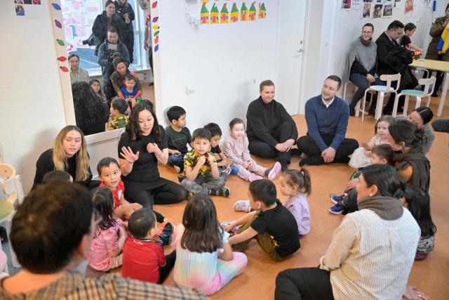 Denmark's Prime Minister Mette Frederiksen and Greenland's Prime Minister Jens-Frederik Nielsen visit a kindergarten in Nuuk, Greenland, on January 23, 2026. Frederiksen held talks with her Greenlandic counterpart after a turbulent week that saw US President Donald Trump back down from his threats to seize the Arctic island and agree to talks. Frederiksen travelled to the Greenland capital Nuuk from Brussels, where she held talks earlier with NATO Secretary General Mark Rutte, who reached a purported deal with Trump on Greenland at the World Economic Forum in Davos. (Photo by Oscar Scott Carl / Ritzau Scanpix / AFP) / Denmark OUT