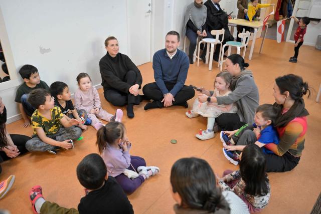 Denmark's Prime Minister Mette Frederiksen and Greenland's Prime Minister Jens-Frederik Nielsen visit a kindergarten in Nuuk, Greenland, on January 23, 2026. Frederiksen held talks with her Greenlandic counterpart after a turbulent week that saw US President Donald Trump back down from his threats to seize the Arctic island and agree to talks. Frederiksen travelled to the Greenland capital Nuuk from Brussels, where she held talks earlier with NATO Secretary General Mark Rutte, who reached a purported deal with Trump on Greenland at the World Economic Forum in Davos. (Photo by Oscar Scott Carl / Ritzau Scanpix / AFP) / Denmark OUT