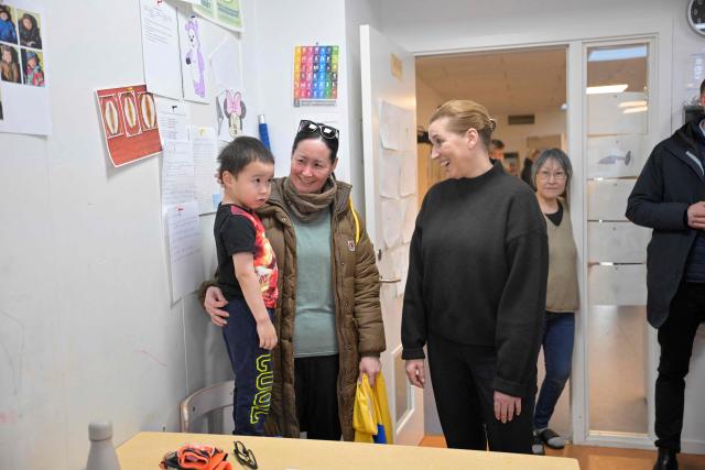 Denmark's Prime Minister Mette Frederiksen and Greenland's Prime Minister Jens-Frederik Nielsen visit a kindergarten in Nuuk, Greenland, on January 23, 2026. Frederiksen held talks with her Greenlandic counterpart after a turbulent week that saw US President Donald Trump back down from his threats to seize the Arctic island and agree to talks. Frederiksen travelled to the Greenland capital Nuuk from Brussels, where she held talks earlier with NATO Secretary General Mark Rutte, who reached a purported deal with Trump on Greenland at the World Economic Forum in Davos. (Photo by Oscar Scott Carl / Ritzau Scanpix / AFP) / Denmark OUT