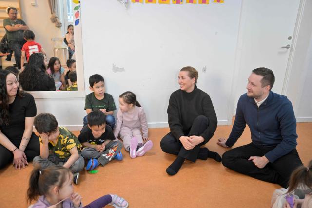 Denmark's Prime Minister Mette Frederiksen and Greenland's Prime Minister Jens-Frederik Nielsen visit a kindergarten in Nuuk, Greenland, on January 23, 2026. Frederiksen held talks with her Greenlandic counterpart after a turbulent week that saw US President Donald Trump back down from his threats to seize the Arctic island and agree to talks. Frederiksen travelled to the Greenland capital Nuuk from Brussels, where she held talks earlier with NATO Secretary General Mark Rutte, who reached a purported deal with Trump on Greenland at the World Economic Forum in Davos. (Photo by Oscar Scott Carl / Ritzau Scanpix / AFP) / Denmark OUT