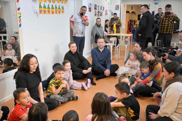 Denmark's Prime Minister Mette Frederiksen and Greenland's Prime Minister Jens-Frederik Nielsen visit a kindergarten in Nuuk, Greenland, on January 23, 2026. Frederiksen held talks with her Greenlandic counterpart after a turbulent week that saw US President Donald Trump back down from his threats to seize the Arctic island and agree to talks. Frederiksen travelled to the Greenland capital Nuuk from Brussels, where she held talks earlier with NATO Secretary General Mark Rutte, who reached a purported deal with Trump on Greenland at the World Economic Forum in Davos. (Photo by Oscar Scott Carl / Ritzau Scanpix / AFP) / Denmark OUT