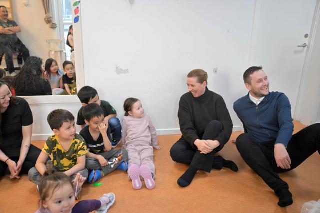 Denmark's Prime Minister Mette Frederiksen and Greenland's Prime Minister Jens-Frederik Nielsen visit a kindergarten in Nuuk, Greenland, on January 23, 2026. Frederiksen held talks with her Greenlandic counterpart after a turbulent week that saw US President Donald Trump back down from his threats to seize the Arctic island and agree to talks. Frederiksen travelled to the Greenland capital Nuuk from Brussels, where she held talks earlier with NATO Secretary General Mark Rutte, who reached a purported deal with Trump on Greenland at the World Economic Forum in Davos. (Photo by Oscar Scott Carl / Ritzau Scanpix / AFP) / Denmark OUT