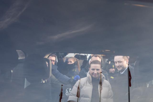 Denmark's Prime Minister Mette Frederiksen and Greenland's Prime Minister Jens-Frederik Nielsen leave the venue after a meeting in Nuuk, Greenland, on January 23, 2026. Frederiksen hold talks with her Greenlandic counterpart after a turbulent week that saw US President Donald Trump back down from his threats to seize the Arctic island and agree to talks. Frederiksen travelled to the Greenland capital Nuuk from Brussels, where she held talks earlier with NATO Secretary General Mark Rutte, who reached a purported deal with Trump on Greenland at the World Economic Forum in Davos. (Photo by Jonathan NACKSTRAND / AFP)
