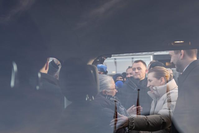 Denmark's Prime Minister Mette Frederiksen and Greenland's Prime Minister Jens-Frederik Nielsen leave the venue after a meeting in Nuuk, Greenland, on January 23, 2026. Frederiksen hold talks with her Greenlandic counterpart after a turbulent week that saw US President Donald Trump back down from his threats to seize the Arctic island and agree to talks. Frederiksen travelled to the Greenland capital Nuuk from Brussels, where she held talks earlier with NATO Secretary General Mark Rutte, who reached a purported deal with Trump on Greenland at the World Economic Forum in Davos. (Photo by Jonathan NACKSTRAND / AFP)