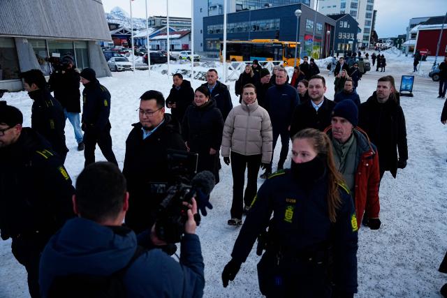 Denmark's Prime Minister Mette Frederiksen and Greenland's Prime Minister Jens-Frederik Nielsen leave after visiting a kindergarten in Nuuk, Greenland, on January 23, 2026. Frederiksen held talks with her Greenlandic counterpart after a turbulent week that saw US President Donald Trump back down from his threats to seize the Arctic island and agree to talks. Frederiksen travelled to the Greenland capital Nuuk from Brussels, where she held talks earlier with NATO Secretary General Mark Rutte, who reached a purported deal with Trump on Greenland at the World Economic Forum in Davos. (Photo by Mads Claus Rasmussen / Ritzau Scanpix / AFP) / Denmark OUT