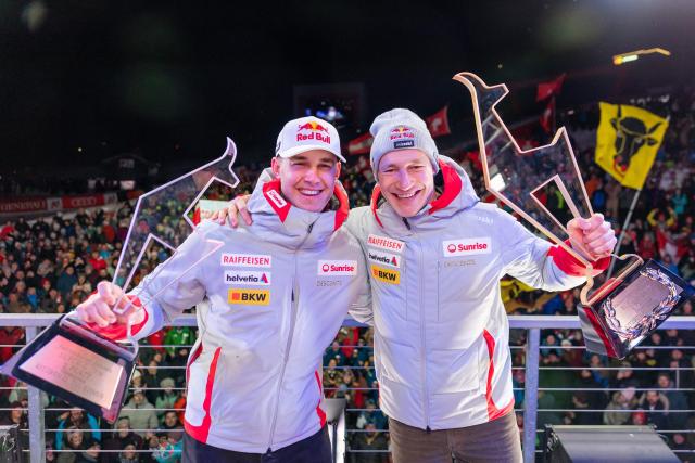 Winner Switzerland's Marco Odermatt and second placed Switzerland's Franjo Von Allmen celebrate with their trophy during the award ceremony for the Men's Super-G event of the FIS Alpine Skiing World Cup in Kitzbuehel, Austria, on January 23, 2026. (Photo by Johann GRODER / APA / AFP) / Austria OUT