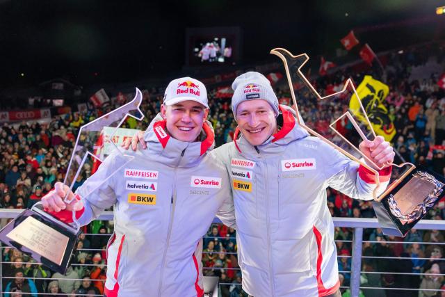 Winner Switzerland's Marco Odermatt and second placed Switzerland's Franjo Von Allmen celebrate with their trophy during the award ceremony for the Men's Super-G event of the FIS Alpine Skiing World Cup in Kitzbuehel, Austria, on January 23, 2026. (Photo by Johann GRODER / APA / AFP) / Austria OUT