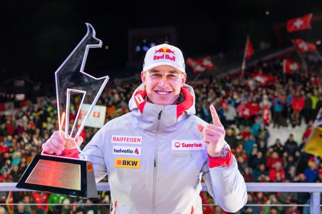 Second placed Switzerland's Franjo Von Allmen celebrates with his trophy during the award ceremony for the Men's Super-G event of the FIS Alpine Skiing World Cup in Kitzbuehel, Austria, on January 23, 2026. (Photo by Johann GRODER / APA / AFP) / Austria OUT