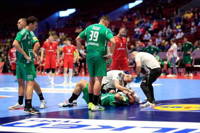 Hungary's pivot #02 Adrian Sipos receives medical attention during the men's EHF Euro 2026 main round handball match Switzerland v Hungary in Malmoe, Sweden, on January 23, 2026. (Photo by Andreas Hillergren/TT / TT NEWS AGENCY / AFP) / Sweden OUT