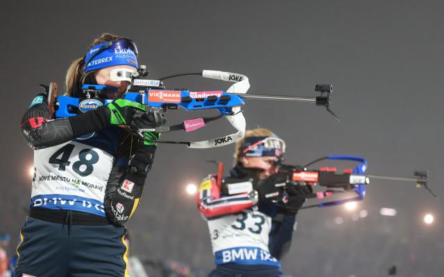 Germany's Franziska Preuss (L) competes next to Norway's Siri Skar on the shooting range of the women's 12,5 km short individual event of the IBU Biathlon World Cup in Nove Mesto, Czech Republic, on January 23, 2026. (Photo by Radek Mi?a / AFP)