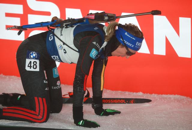 Germany's Franziska Preuss kneels after finishing the women's 12,5 km short individual event of the IBU Biathlon World Cup in Nove Mesto, Czech Republic, on January 23, 2026. (Photo by Radek Mi?a / AFP)