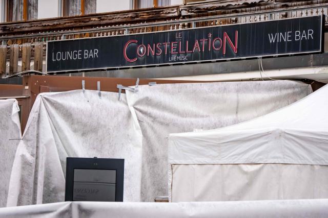 (FILES) This photograph shows the entrance of the bar Le Constellation where a fire ripped through the venue during New Year's celebrations in the Alpine ski resort town of Crans-Montana killing around 40 people and injuring more than 100 others, in Crans-Montana on January 2, 2026. The co-owner of the Swiss bar hit by a deadly fire during New Year celebrations was allowed to walk free from custody on January 23, 2026, after bail was paid on his behalf. Jacques Moretti, 49, and his 39-year-old wife Jessica, who are both French, co-own Le Constellation, a bar in the ski resort of Crans-Montana in southern Switzerland. (Photo by MAXIME SCHMID / AFP)
