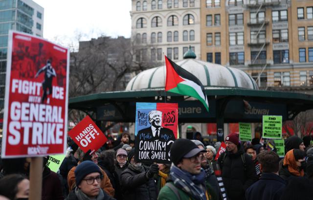 People hold anti-Trump signs as they march in an "ICE Out" protest in New York on January 23, 2026 against US Immigration and Customs Enforcement (ICE). Demonstrations against ICE grew dramatically following the killing of Renee Nicole Good, 37, by an ICE officer in Minneapolis on January 7 as the Trump administration pressed operations to catch undocumented migrants. (Photo by ANGELA WEISS / AFP)
