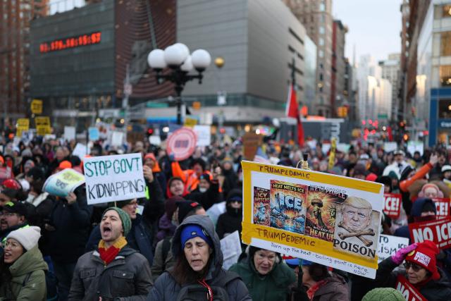 People hold anti-Trump signs as they march in an "ICE Out" protest in New York on January 23, 2026 against US Immigration and Customs Enforcement (ICE). Demonstrations against ICE grew dramatically following the killing of Renee Nicole Good, 37, by an ICE officer in Minneapolis on January 7 as the Trump administration pressed operations to catch undocumented migrants. (Photo by ANGELA WEISS / AFP)