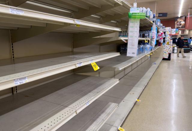 Empty shelves are seen as residents stock up on supplies ahead of a cold front expected in the area in Arlington, Virginia, on January 23, 2026. A massive winter storm was set to drop a mix of freezing rain and heavy snow on some 160 million Americans starting January 23, threatening to bring dangerously icy conditions. Multiple US states declared states of emergency as meteorologists said the storm would soon begin marching across much of the continental US, covering a wide swath of the country's middle including the Rockies and Plains. (Photo by SAUL LOEB / AFP)