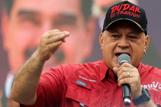 Venezuela's Minister of the Interior and Justice, Diosdado Cabello, gestures as he speaks during a demonstration by supporters of ousted President Nicolas Maduro calling for the release of him and his wife from a US prison in Caracas on January 23, 2026. Thousands of Nicolas Maduro's supporters marched in Caracas on January 23, calling for the release of the ousted president, as Venezuela marked the 68th anniversary of the fall of military dictatorship. (Photo by Pedro MATTEY / AFP)