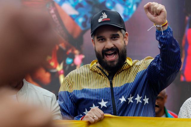 Deputy Nicolas Maduro Guerra, son of Venezuela's ousted President Nicolas Maduro, gestures during a demonstration by supporters calling for the release of the ousted president and his wife from a US prison in Caracas on January 23, 2026. Thousands of Nicolas Maduro's supporters marched in Caracas on January 23, calling for the release of the ousted president, as Venezuela marked the 68th anniversary of the fall of military dictatorship. (Photo by Pedro MATTEY / AFP)