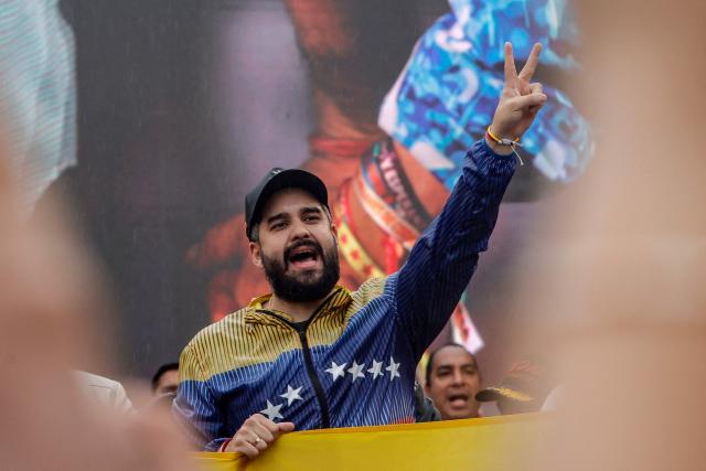 Deputy Nicolas Maduro Guerra, son of Venezuela's ousted President Nicolas Maduro, gestures during a demonstration by supporters calling for the release of the ousted president and his wife from a US prison in Caracas on January 23, 2026. Thousands of Nicolas Maduro's supporters marched in Caracas on January 23, calling for the release of the ousted president, as Venezuela marked the 68th anniversary of the fall of military dictatorship. (Photo by Pedro MATTEY / AFP)