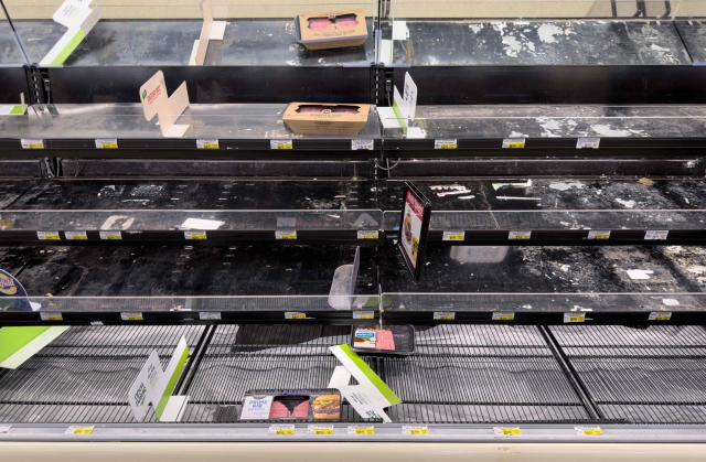 Shelves sit empty in the butcher section as residents stock up on supplies ahead of a cold front expected in the area in Arlington, Virginia, on January 23, 2026. A massive winter storm was set to drop a mix of freezing rain and heavy snow on some 160 million Americans starting January 23, threatening to bring dangerously icy conditions. Multiple US states declared states of emergency as meteorologists said the storm would soon begin marching across much of the continental US, covering a wide swath of the country's middle including the Rockies and Plains. (Photo by SAUL LOEB / AFP)