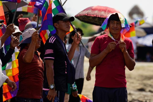 A man wears a Wiphala flag to protect him from the sun during the celebrations marking the Day of the Plurinational State, in the town of Lauca Ene, Shinaota, Bolivia, on January 23, 2026. (Photo by Pablo Rivera / AFP)
