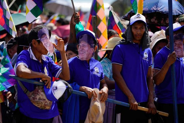 Men wearing masks depicting former Bolivian President Evo Morales take part in the celebrations marking the Day of the Plurinational State, in Shinaota, Bolivia, on January 23, 2026. (Photo by Pablo Rivera / AFP)
