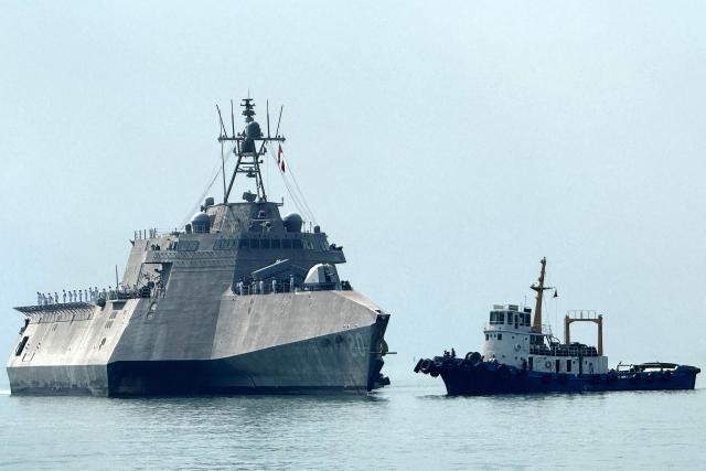 The US Navy's USS Cincinnati (LCS-20) littoral combat ship (L) arrives for a port call at the Ream Naval base, located in Cambodia's southern coast in Preah Sihanouk province, on January 24, 2026. (Photo by Suy SE / AFP)