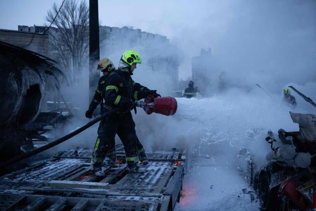 Ukrainian emmergency personnel work to extinguish a fire at the site of an air attack in Kyiv on January 24, 2026, amid the Russian invasion of Ukraine. Russian strikes killed one person and injured 23 others in Ukraine's capital and the northeastern city of Kharkiv overnight, authorities said early on January 24, 2026. The country was under an air raid alert with military authorities in Kyiv warning of drones and ballistic missiles. (Photo by Oleksandr Magula / AFP)