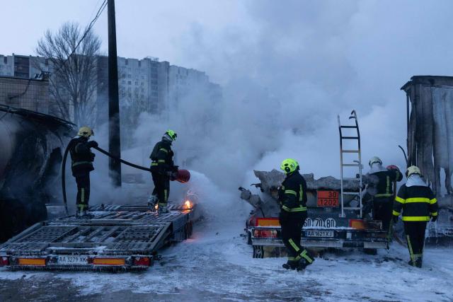 Ukrainian emmergency personnel work to extinguish a fire at the site of an air attack in Kyiv on January 24, 2026, amid the Russian invasion of Ukraine. Russian strikes killed one person and injured 23 others in Ukraine's capital and the northeastern city of Kharkiv overnight, authorities said early on January 24, 2026. The country was under an air raid alert with military authorities in Kyiv warning of drones and ballistic missiles. (Photo by Oleksandr Magula / AFP)
