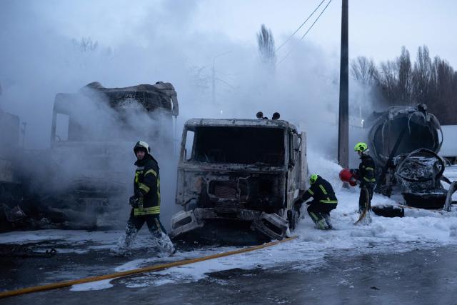 Ukrainian emmergency personnel work to extinguish a fire at the site of an air attack in Kyiv on January 24, 2026, amid the Russian invasion of Ukraine. Russian strikes killed one person and injured 23 others in Ukraine's capital and the northeastern city of Kharkiv overnight, authorities said early on January 24, 2026. The country was under an air raid alert with military authorities in Kyiv warning of drones and ballistic missiles. (Photo by Oleksandr Magula / AFP)