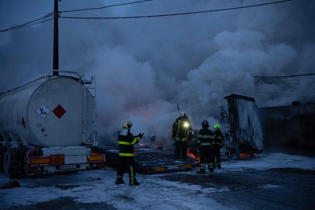 Ukrainian emmergency personnel work to extinguish a fire at the site of an air attack in Kyiv on January 24, 2026, amid the Russian invasion of Ukraine.. Russian strikes killed one person and injured 23 others in Ukraine's capital and the northeastern city of Kharkiv overnight, authorities said early on January 24, 2026. The country was under an air raid alert with military authorities in Kyiv warning of drones and ballistic missiles. (Photo by Oleksandr Magula / AFP)