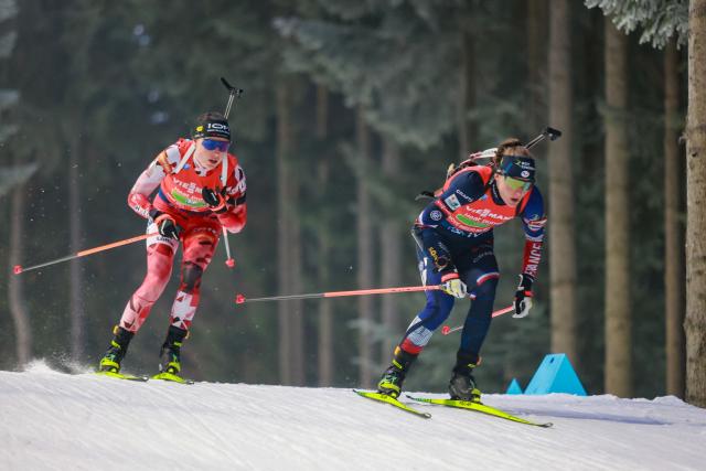 France's Justine Braisaz (R) and Austria's Anna Juppe (L) compete during the mixed relay event of the IBU Biathlon World Championships in Nove Mesto, Czech Republic on January 24, 2026. (Photo by Radek MICA / AFP)