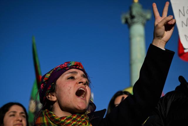 A protester chants slogans during a demonstration in solidarity with Kurds in northern Syria, in central Paris, on January 24, 2026. More than 134,000 people have been displaced in northeast Syria, according to the United Nations said on January 22, after clashes and a fragile ceasefire deal between government troops and the Kurdish-led Syrian Democratic Forces (SDF). (Photo by Blanca CRUZ / AFP)