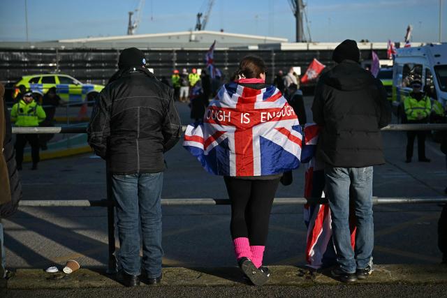 Right wing protesters gather outside a processing centre for migrants in Dover on the south east coast of England on January 24, 2026. (Photo by JUSTIN TALLIS / AFP)