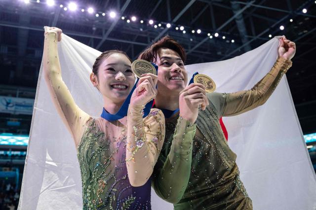 Japan's Yuna Nagaoka (L) and Sumitada Moriguchi celebrate with their medals after finishing third in the pairs competition at the ISU Four Continents Figure Skating Championships in Beijing on January 24, 2026. (Photo by GREG BAKER / AFP)